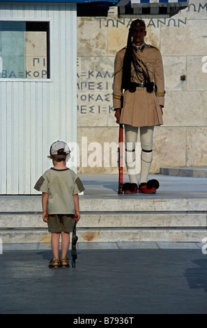 Evzone guarding the Tomb of the Unknown Soldier in Athens being copied by a small boy. Greece Stock Photo