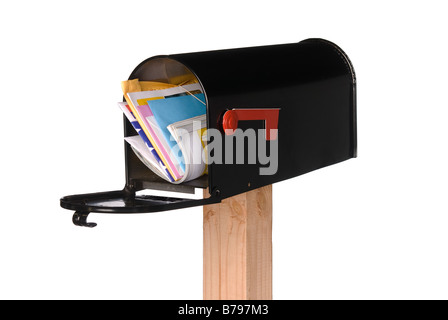 A black isolated mailbox filled with letters bills greeting cards and a magazine Stock Photo