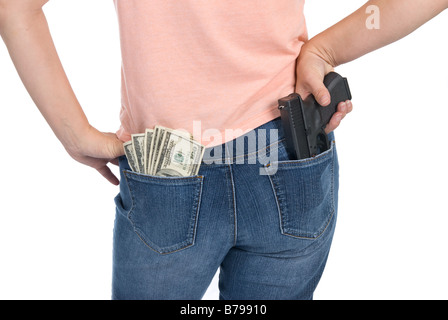 A woman is prepared to defend her cash with a semi automatic handgun Stock Photo