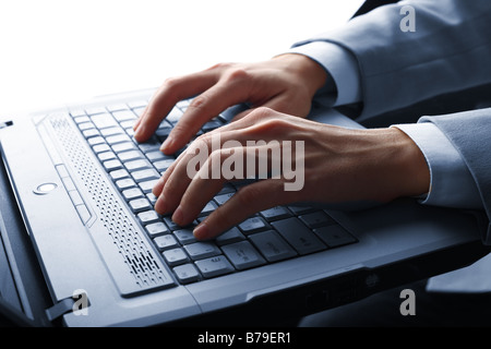 male hands typing on a laptop Stock Photo