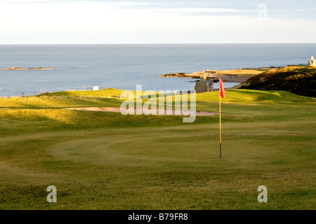 Hole with flag on a golf course overlooking the Moray Firth in Buckie, Scotland Stock Photo