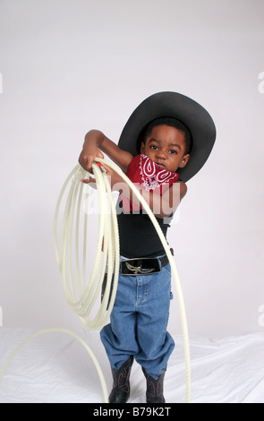 African American boy  in  cowboy outfit, with bandanna and rope Stock Photo
