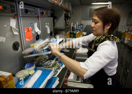 Member of cabin crew organising special meals on a Gulf Air aircraft during flight to Bahrain from London. (45) Stock Photo