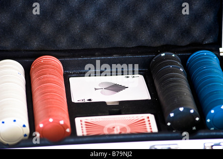 Casino / poker chips and playing cards displayed in a case Stock Photo