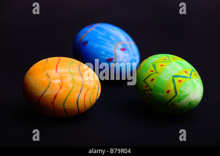 Orange, blue and green Easter eggs on black background Stock Photo