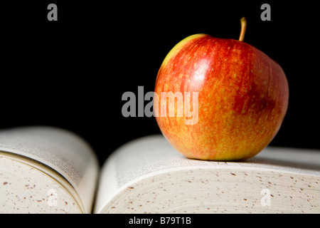 Apple on book Stock Photo