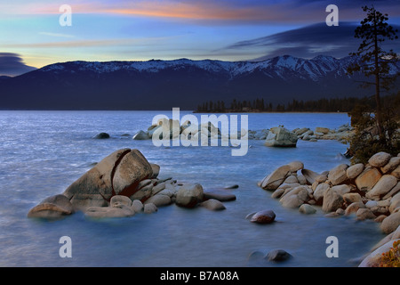 Whale rock and snowy mountains on the east shore of Lake Tahoe in the spring Stock Photo