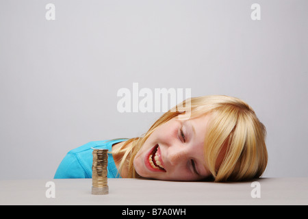 Girl with a stack of coins Stock Photo