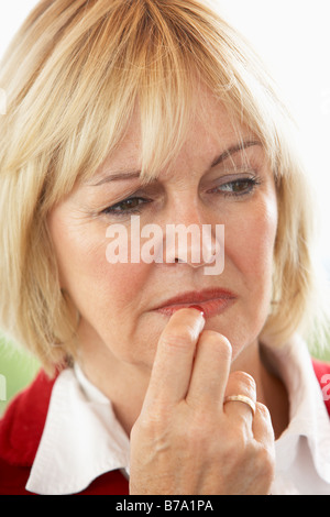 Portrait Of Middle Aged Woman Frowning Stock Photo