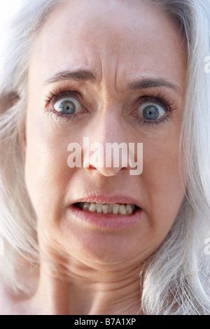 Portrait Of Senior Woman Looking Shocked Stock Photo