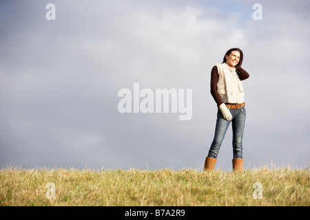 Young Woman Standing In Park Stock Photo