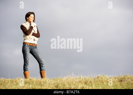 Young Woman Standing In Park Stock Photo
