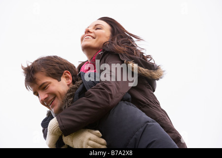 Man Giving His Wife Piggy Back Ride Stock Photo