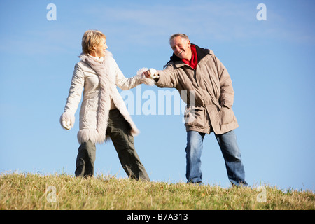 Senior Man Pulling His Wife By The Hand Stock Photo