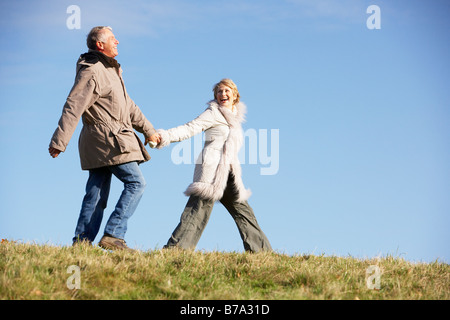 Senior Man Pulling His Wife By The Hand Stock Photo