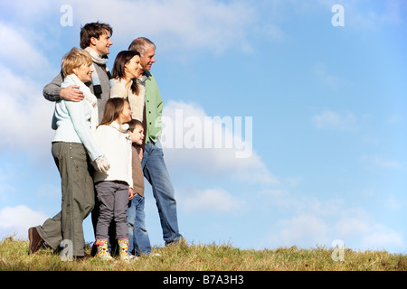 Family Standing In The Park Stock Photo