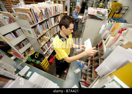 Employee, mailman, of the Deutsche Post AG, German post, sorting his mail in the Regensburg delivery post, Bavaria, Germany, Eu Stock Photo