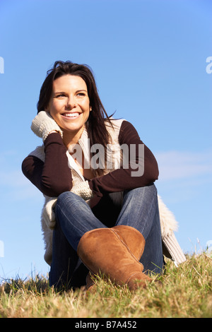 Young Woman Sitting In Park Stock Photo