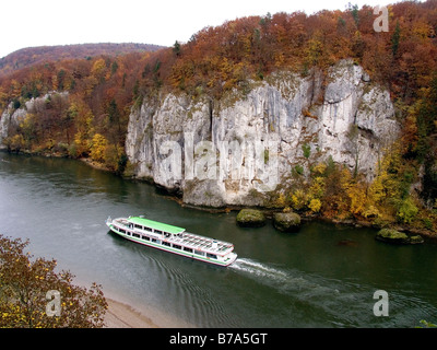 Excursion vessel on the Danube navigating through the Donaudurchbruch where the Danube breaks through the cliffs near Kelheim,  Stock Photo
