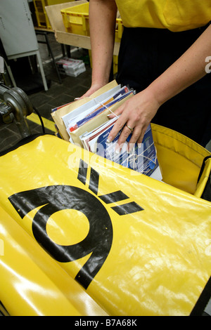 Employee, mailwoman, of the Deutsche Post AG, packing her delivery bags on the letter cart, Regensburg delivery post, Bavaria, 