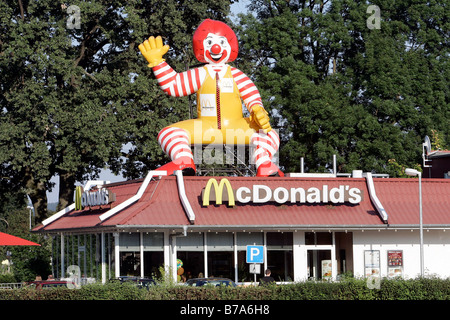 McDonald's chain store with a rubber Ronald McDonald on the roof, Landau an der Isar, Bavaria, Germany, Europe Stock Photo