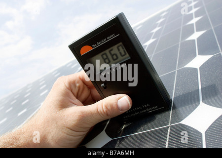 Manual measurement of solar radiation at a photovoltaic module of the Powerlight Company in the Bavarian Solar Park Muehlhausen Stock Photo
