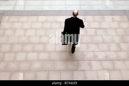 Businessman with a briefcase, walking in Canary Wharf in London, England, Great Britain, Europe Stock Photo