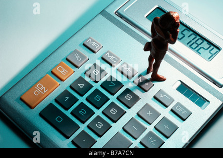Miniature figure on calculator Stock Photo