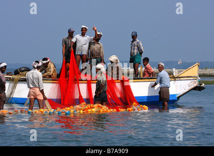 Fishermen fishing on a boat in Kollam, Kerala, India, South Asia Stock Photo