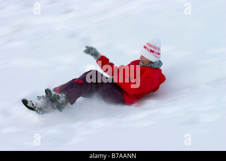 Girl 12 years old riding on snow-slider, Dolomites, Italy, Europe Stock Photo