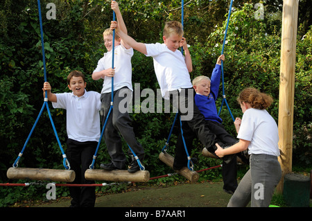 Boy bullying and pushing girls in a primary school play area. UK Stock ...