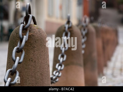 Stone bollard with steel chain on a small access road in Heidelberg, Baden-Wuerttemberg, Germany, Europe Stock Photo