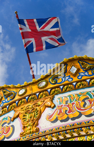 Flag of the United Kingdom above a carousel on the pier in Brighton, Sussex, Great Britain, Europe Stock Photo