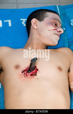 Knife stab injury in a male chest blood from nose signifies a punctured lung Mock up with make up Stock Photo