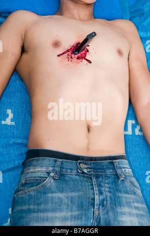 Knife stab injury in a male chest. Mock up with make up Stock Photo