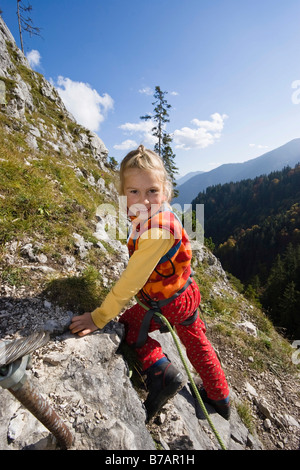 Girl, 5, climbing on Kofel mountain in the Upper Ammergauer Alps, Upper Bavaria, Bavaria, Germany, Europe Stock Photo