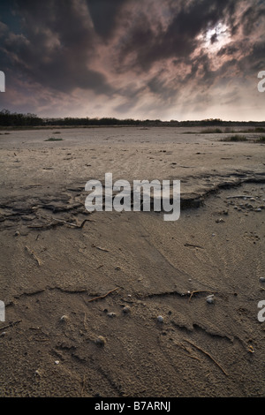 Setting sun over a dried out salt lake. La Sal Del Rey, Texas, United States. Stock Photo