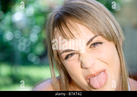 Teenaged Girl Sticking Out Her Tongue
