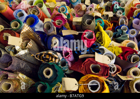 Various rolls of uncut colourful colorful material for sale in a dress making shop. Stock Photo