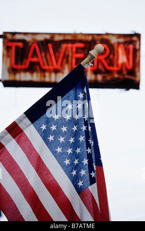 American Flag in Front of Tavern Sign Stock Photo