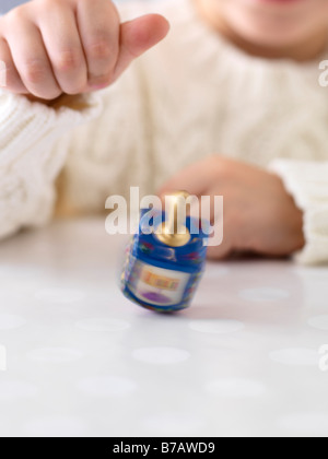 Boy Spinning Dreidel Stock Photo