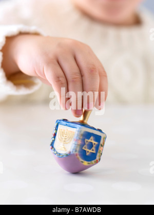 Boy Spinning Dreidel Stock Photo