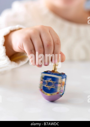 Boy Spinning Dreidel Stock Photo