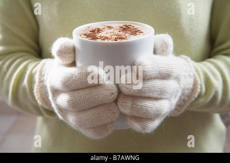 Close-up of Woman Holding Mug of Hot Chocolate Stock Photo