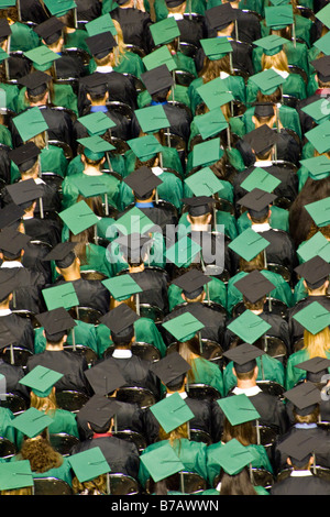 High school students in caps and gowns look forward to future after graduation. Stock Photo