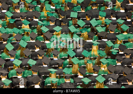 High school students in caps and gowns look forward to future after graduation. Stock Photo
