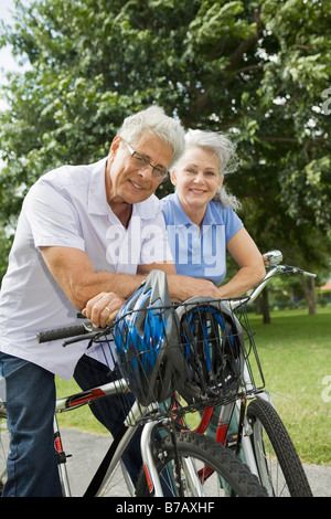 Baby-Boomer Couple Riding Bikes Stock Photo