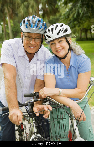 Baby Boomer Couple Riding Bikes Stock Photo
