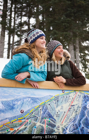 Woman in Winter Clothing by Map Sign, Government Camp, Oregon, USA Stock Photo