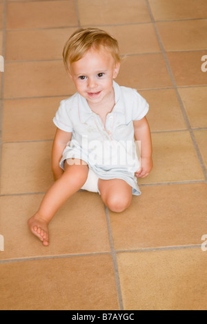 Little Boy Sitting on the Floor Stock Photo